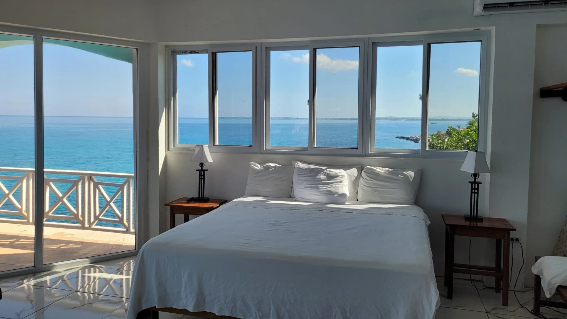 King bed beneath sea-view windows in the New Penthouse, Room 19