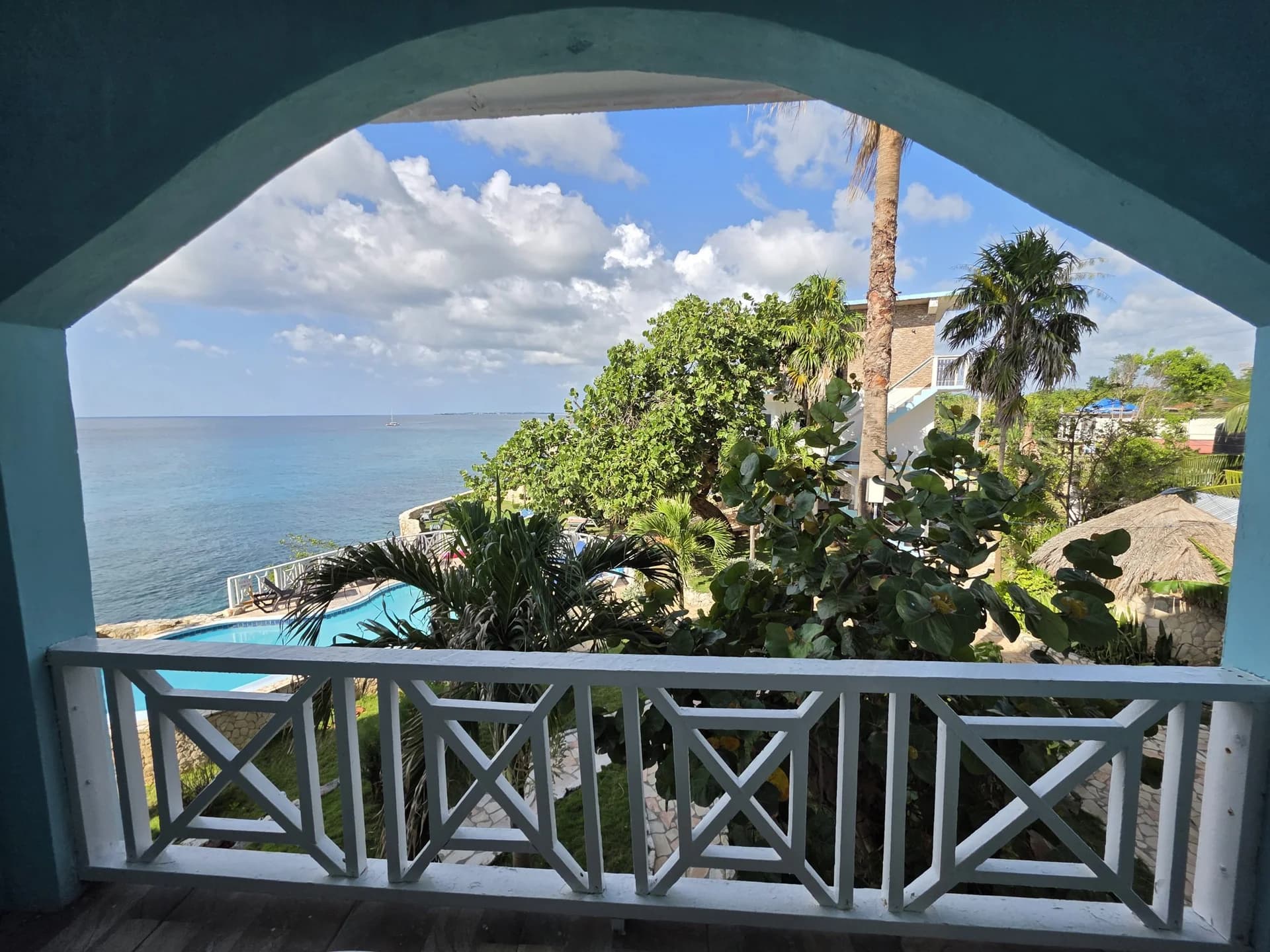 Balcony overlooking the cliffside pool and the sea from Seaview Deluxe Room 8
