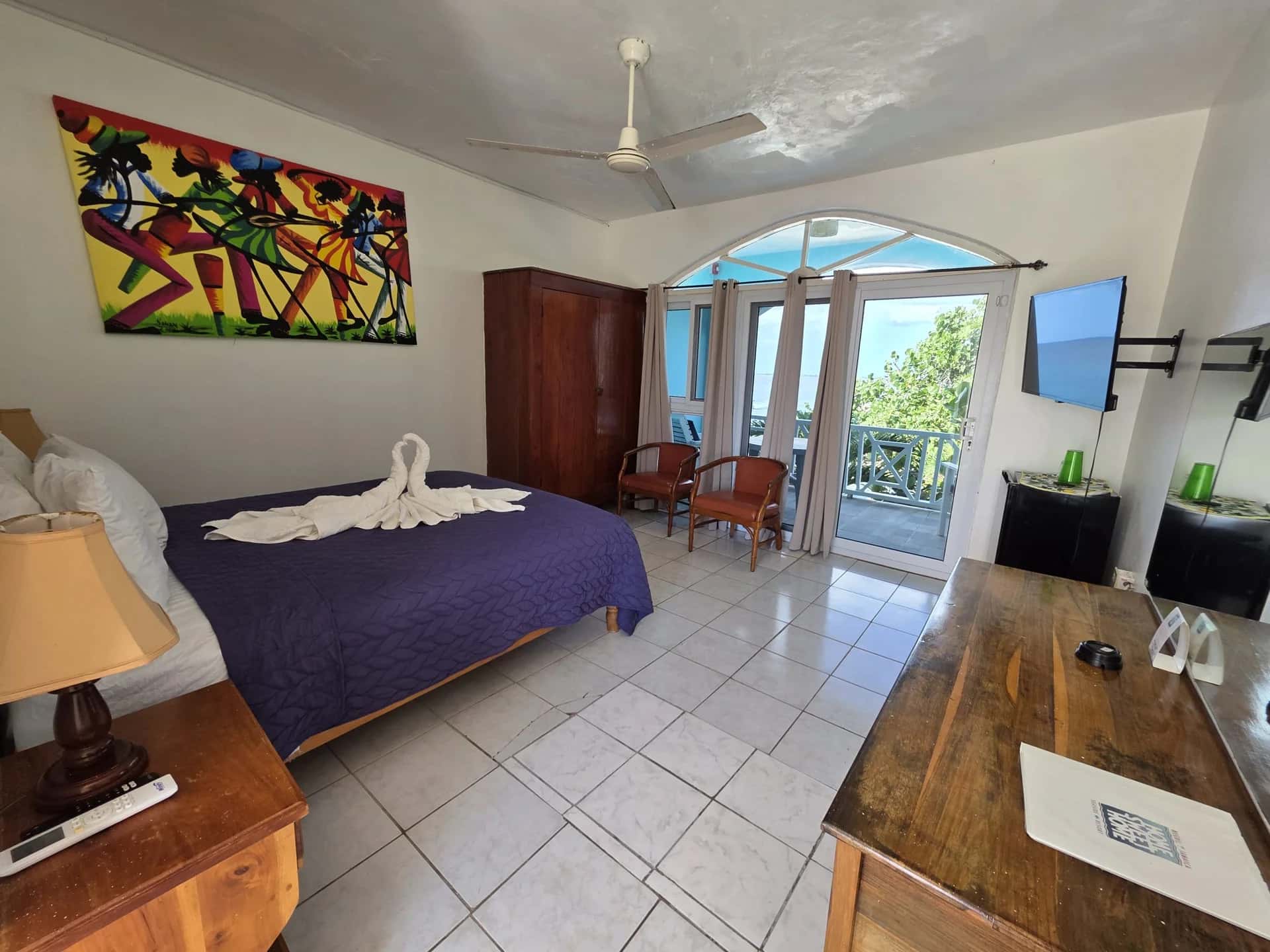 Queen bed with sea-view balcony doors in Seaview Deluxe Queen Room 8