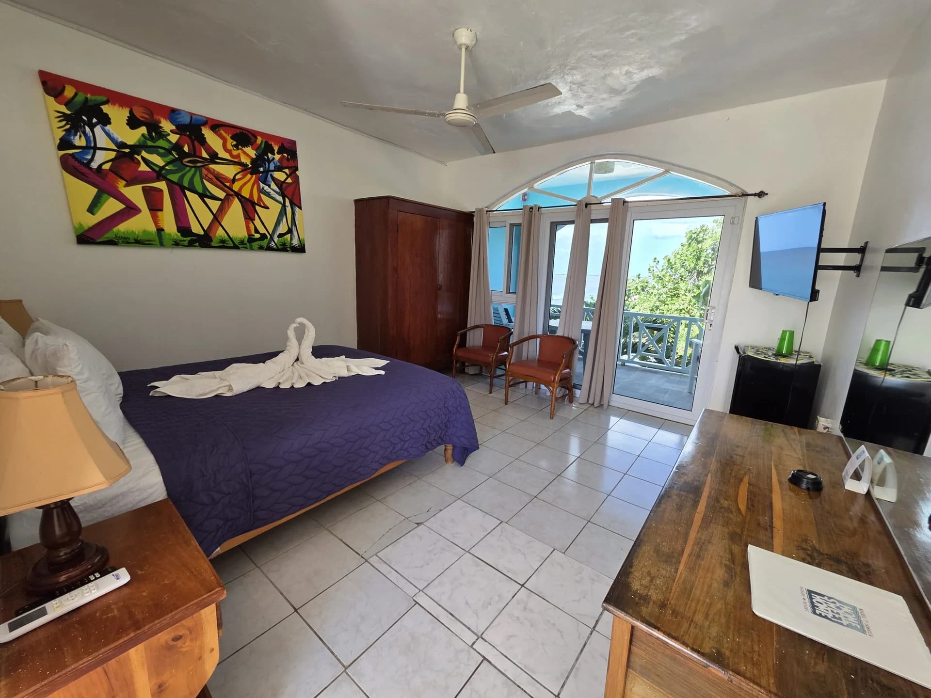 Queen bed with sea-view balcony doors in Seaview Deluxe Queen Room 8
