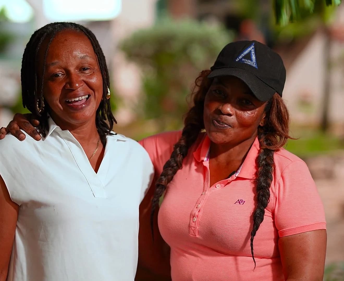 Two of our housekeepers, arm in arm and smiling in the garden